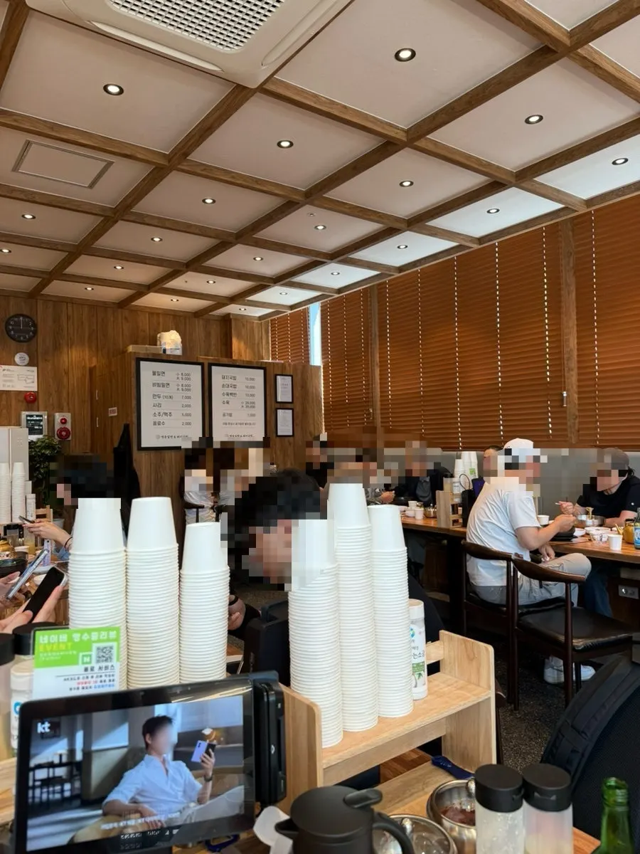 A table spread of milmyeon, broth, and dumplings