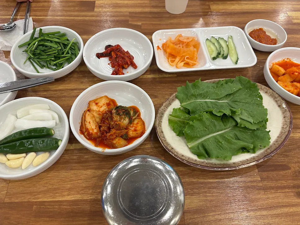 Table spread with dwaeji gukbap and side dishes