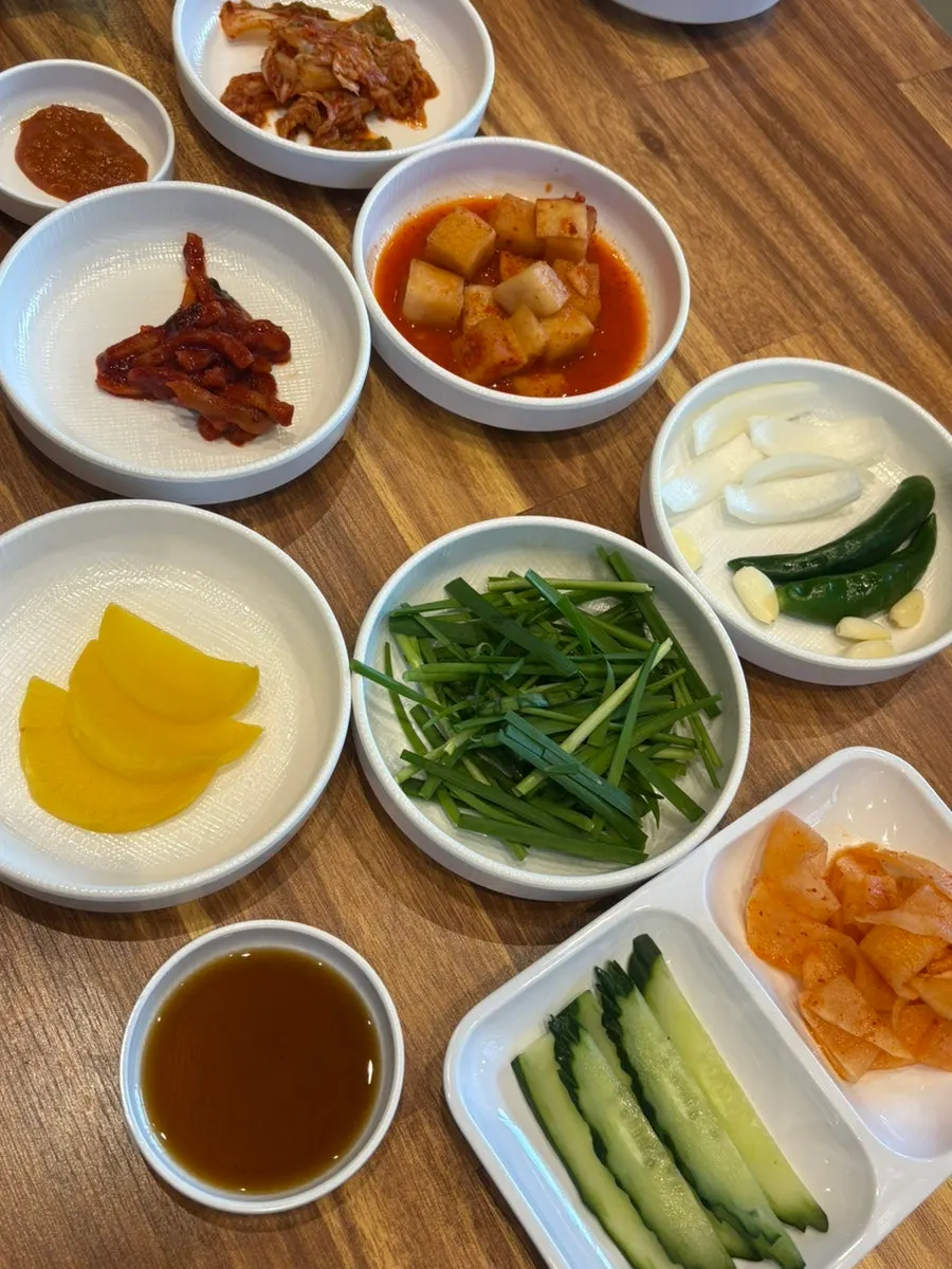 Table with ordered dwaeji gukbap and bibim milmyeon