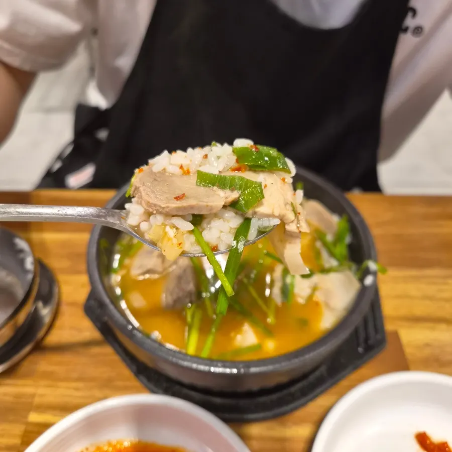 Milky broth gukbap next to red dadegi-seasoned dwaeji gukbap