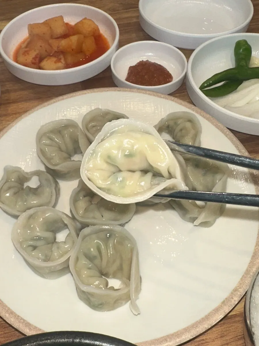 A plate of hand-made dumplings with a full filling