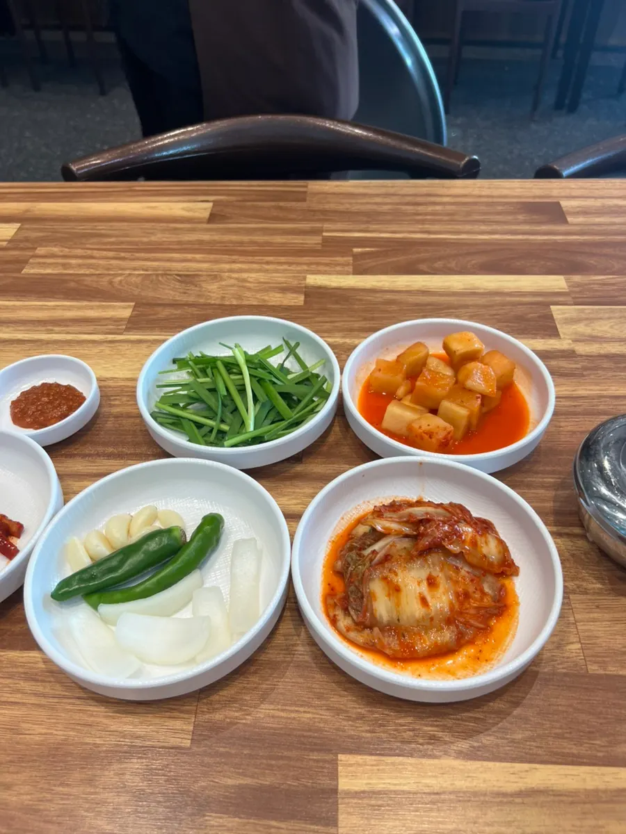 A plate of kkakdugi, chili peppers, and garlic