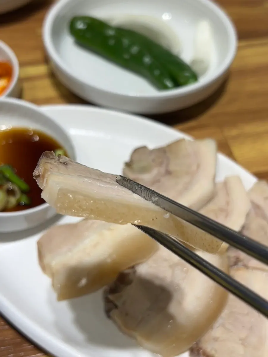 Close-up of the milky-white dwaeji gukbap broth