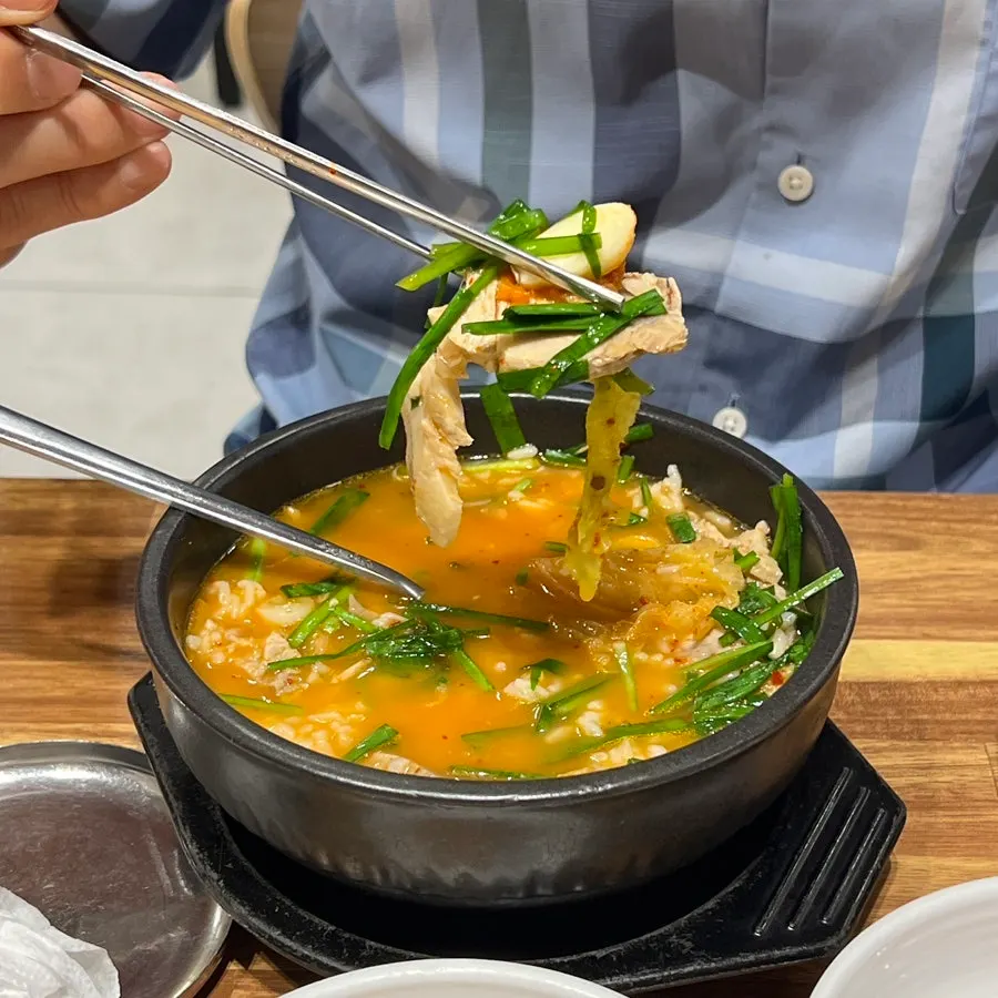 Reddened, seasoned dwaeji gukbap broth