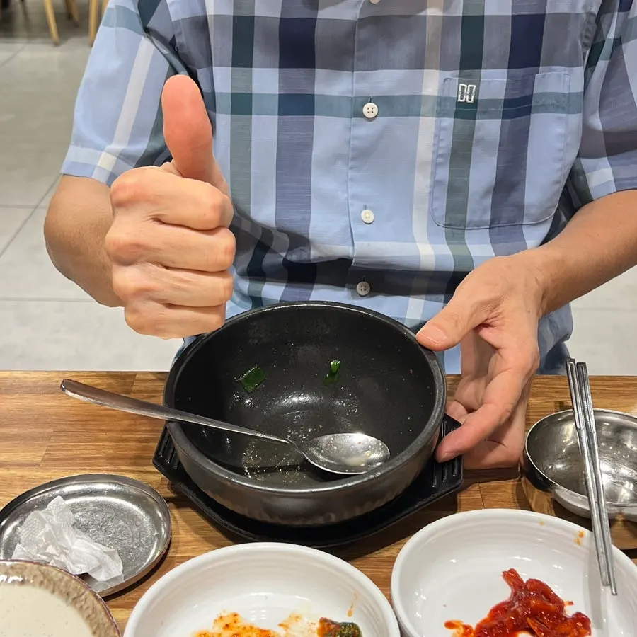 An empty dwaeji gukbap bowl, broth and all finished