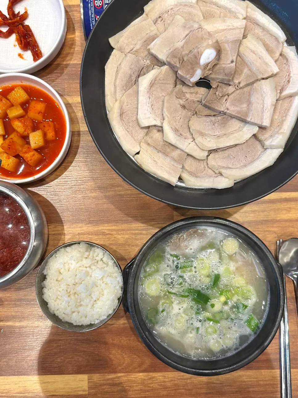 Table setting of dwaeji gukbap with side dishes