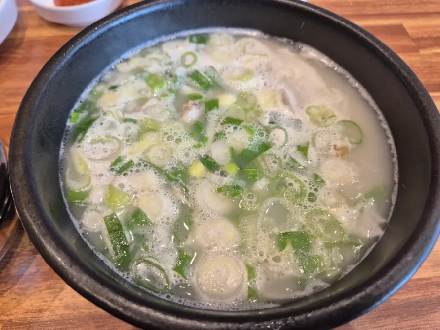 A table set with sundae gukbap, dwaeji gukbap, and subaek