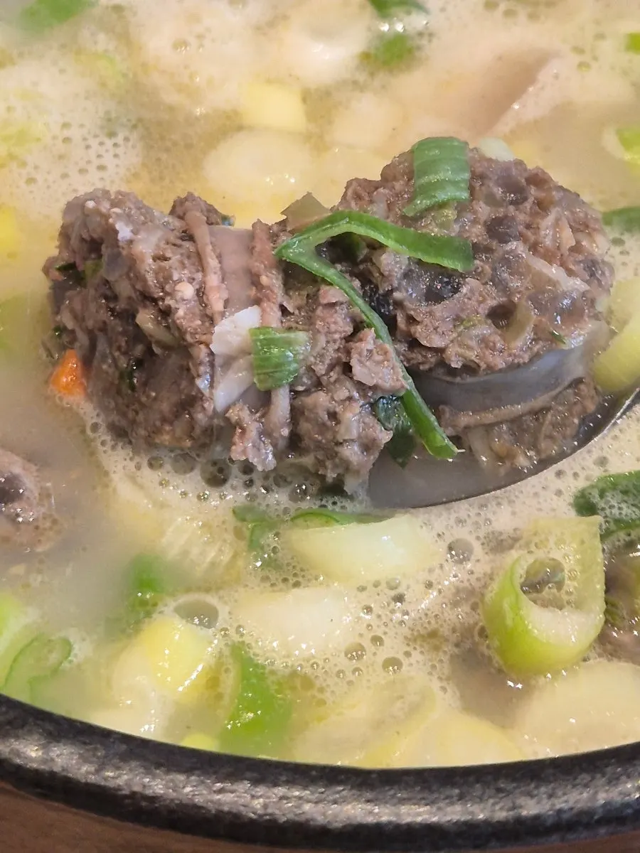 Sundae soaked in broth alongside rice