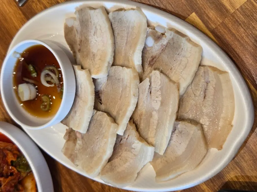 Boiled pork, rice, and accompanying side dishes
