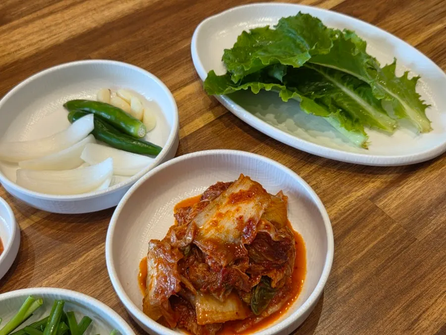 A table set centered around boiled pork