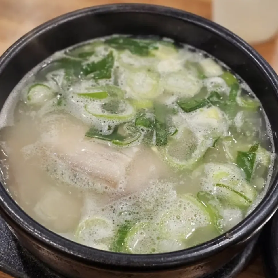 Bowl of dwaeji gukbap with milky broth