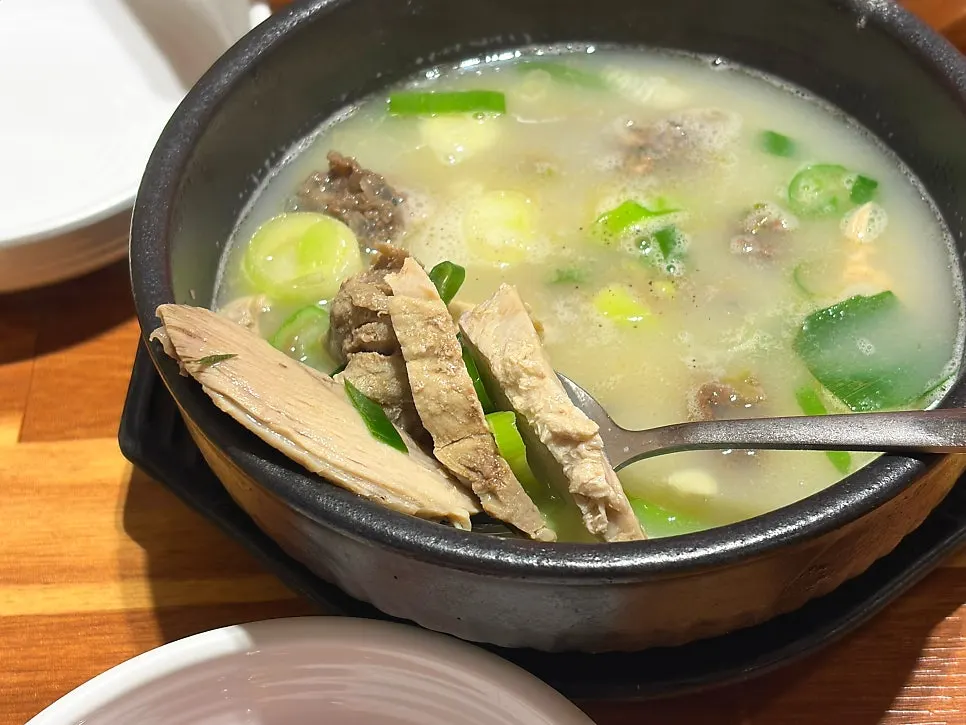 Stone bowl of sundae gukbap filled with milky broth