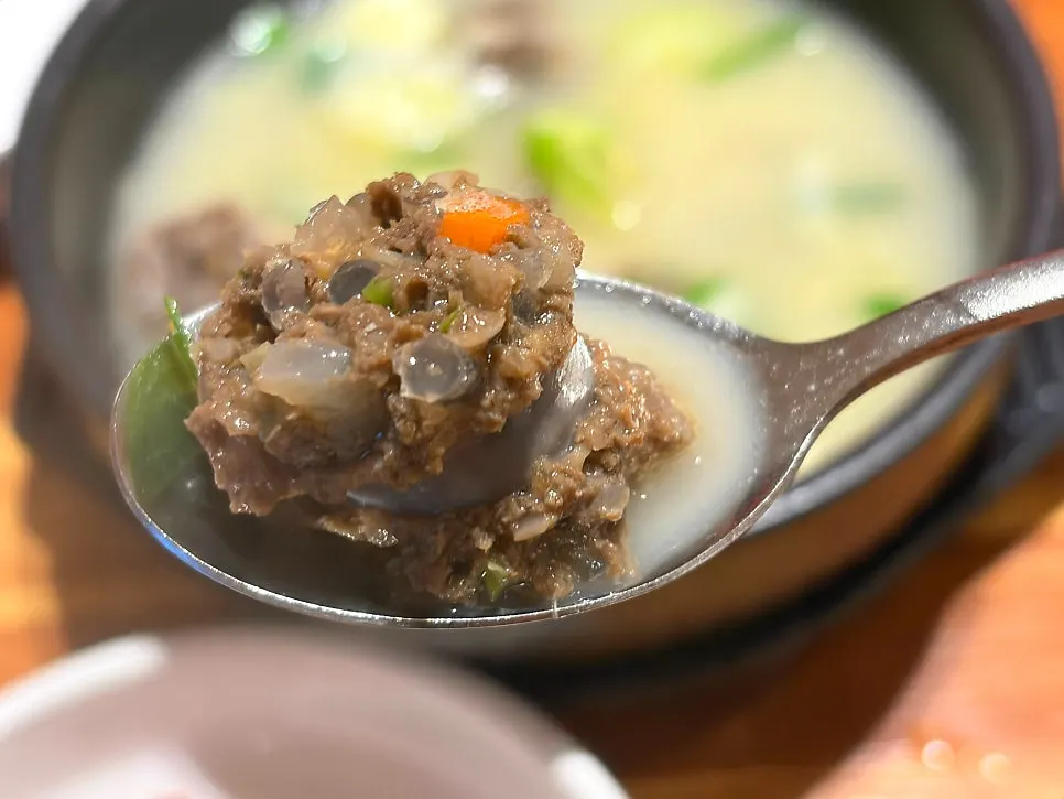 Meat sundae lifted on a spoon