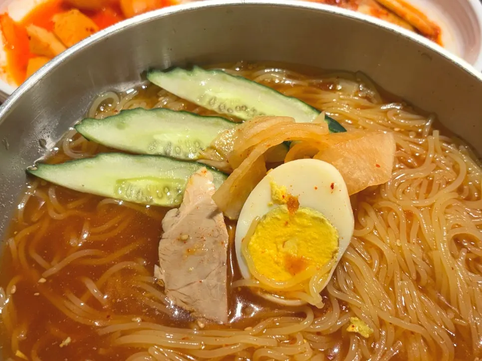 Pickled radish served alongside the milmyeon