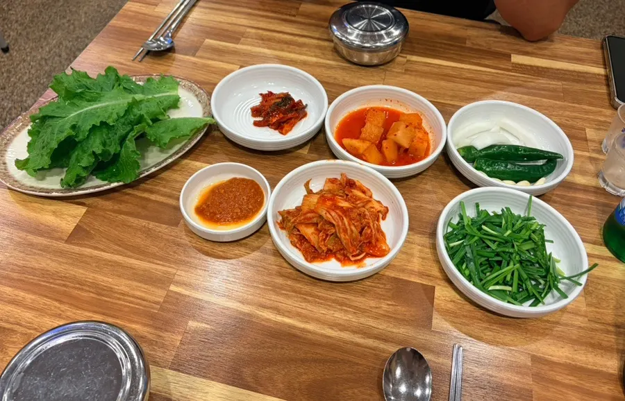 Menu board listing pork soup and milmyeon noodles