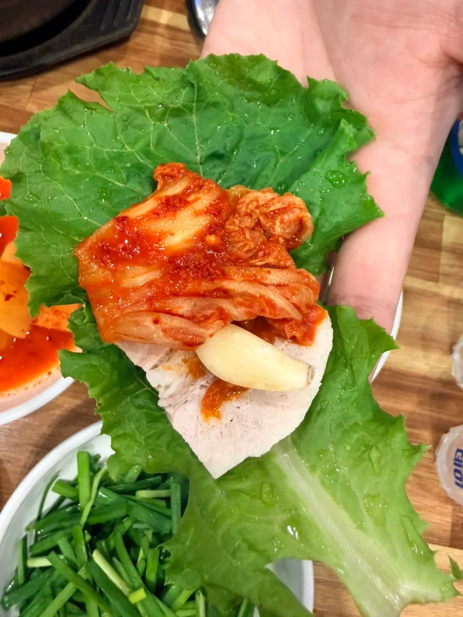 A slice of boiled pork dipped in sauce