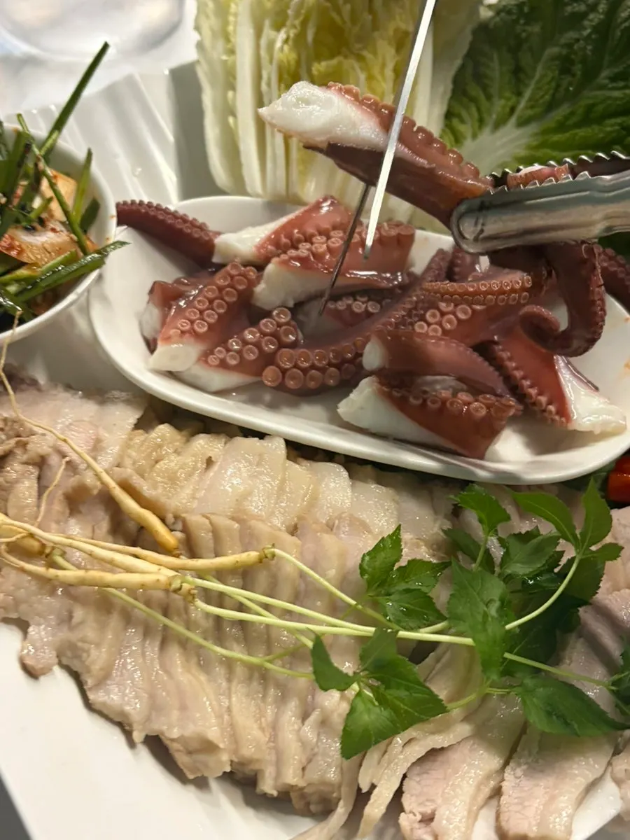 Whole octopus and boiled pork served together as octopus seaweed bossam