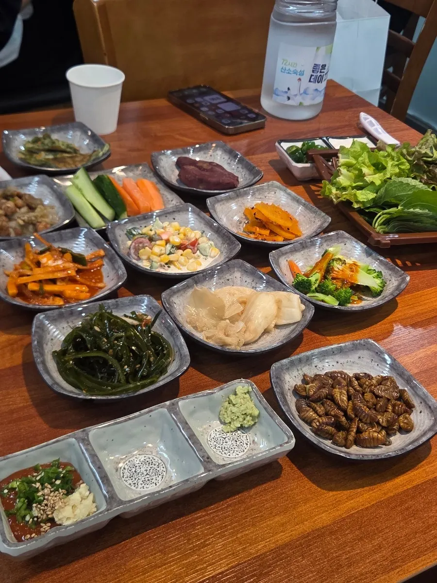 Banchan including seasoned bellflower root and silkworm pupae