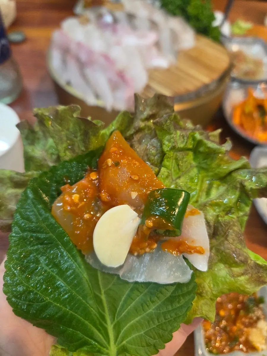 Assorted sashimi eaten in vegetable wraps