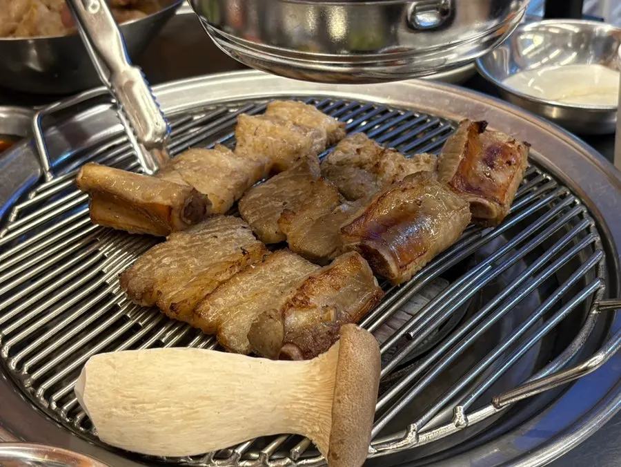 Seasoned pork ribs placed on the grill
