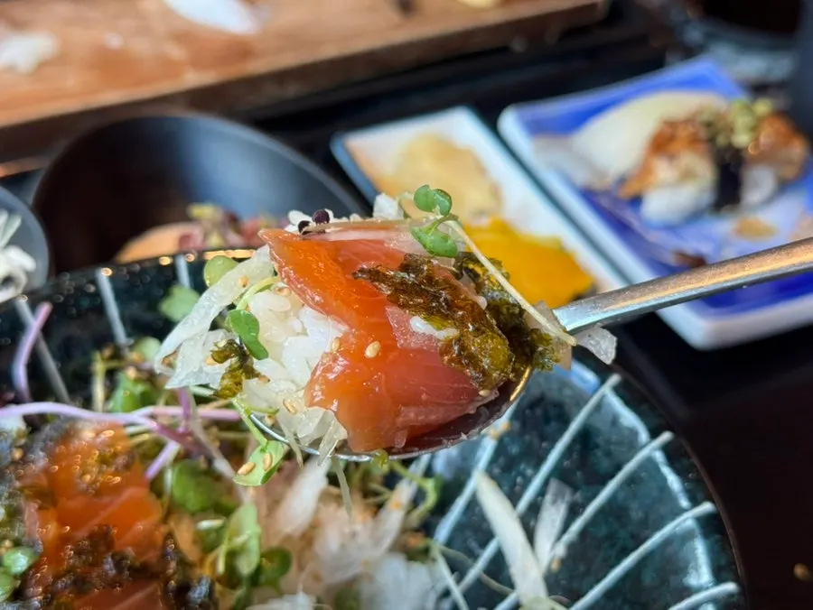 Salmon soy-marinated rice bowl with seaweed and wasabi