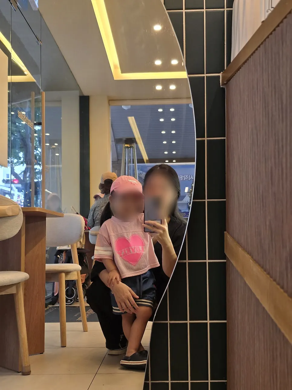 Selfie with baby in front of the café mirror