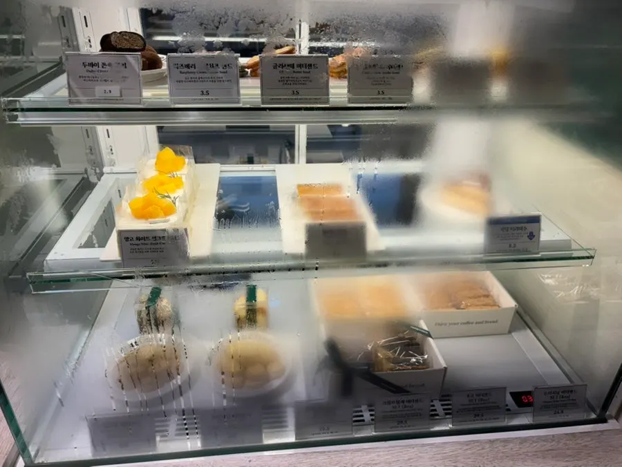 Fridge case beside the counter holding sand cookies