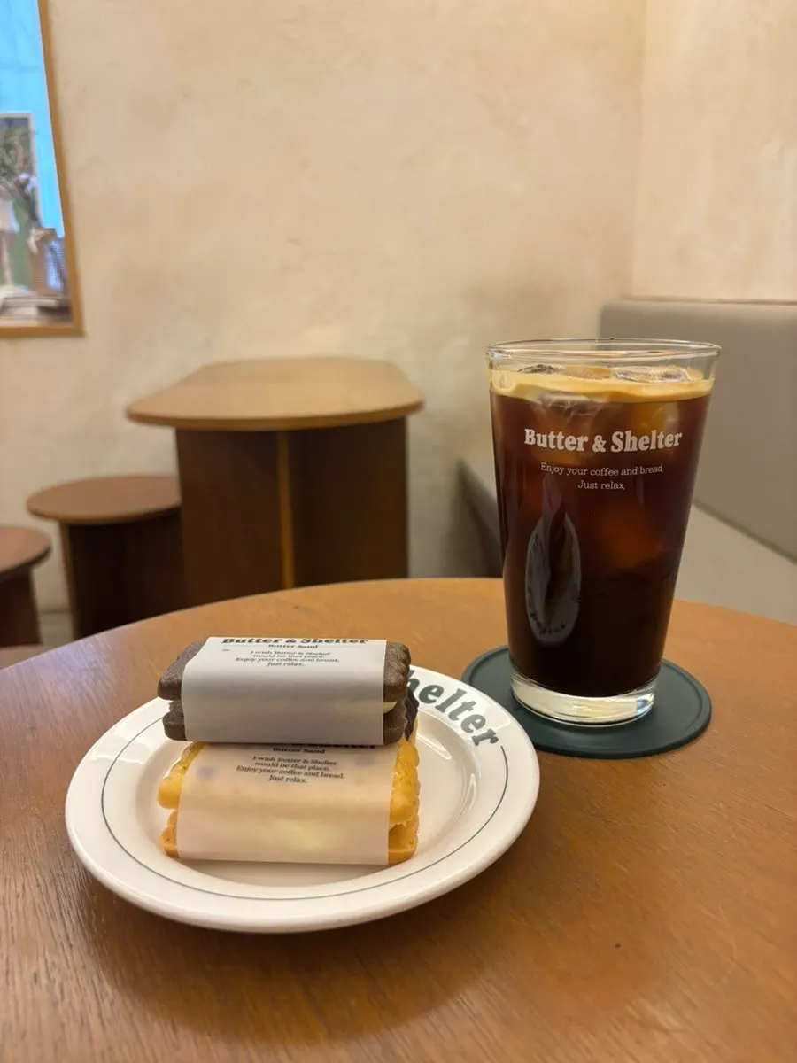 Table setting with iced americano and sand cookies
