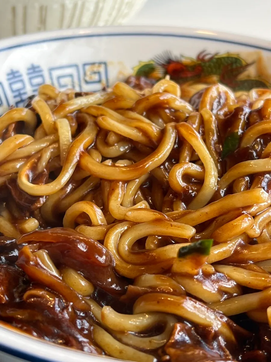Bowl of jjajangmyeon loaded with sauce