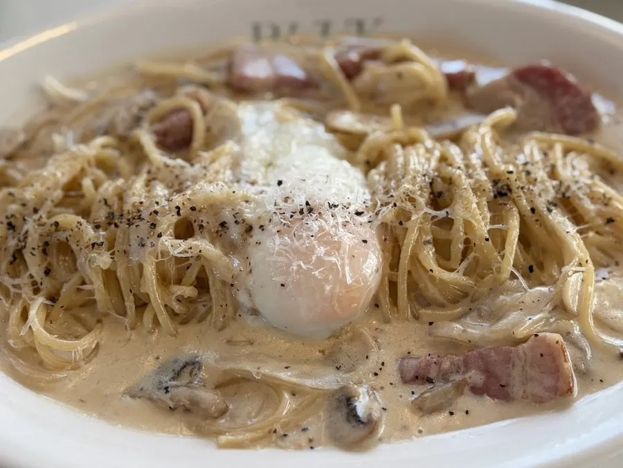 Carbonara topped with a poached egg