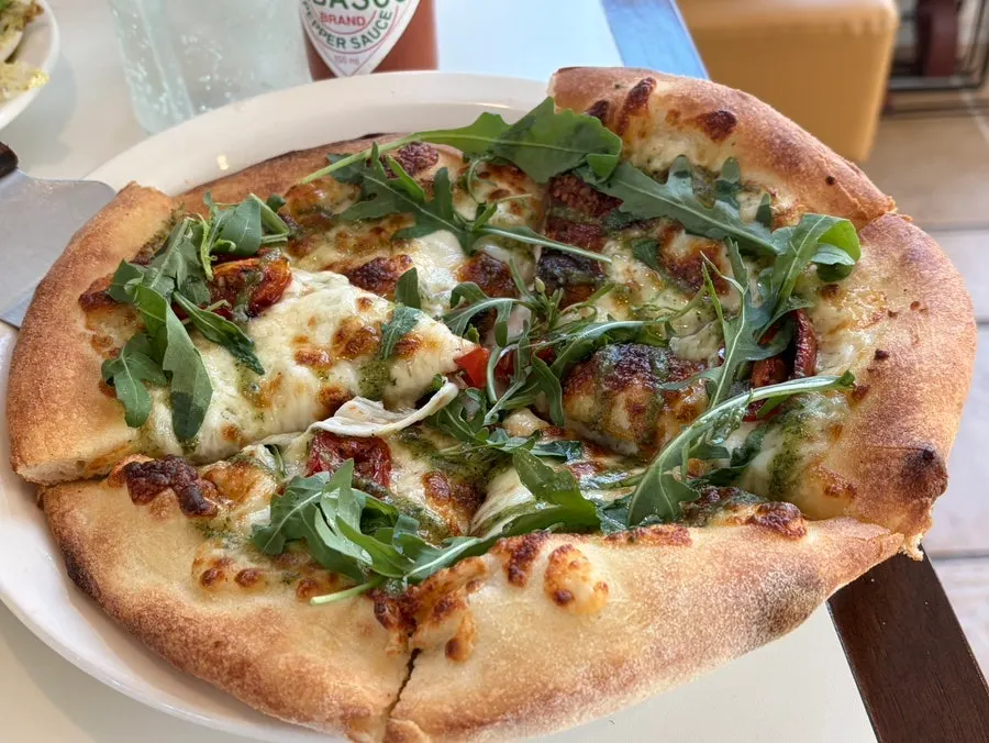 A whole basil Margherita pizza