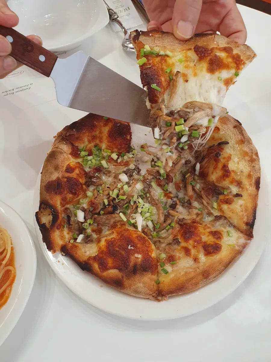 Truffle mushroom pizza topped with truffle oil and chopped green onion