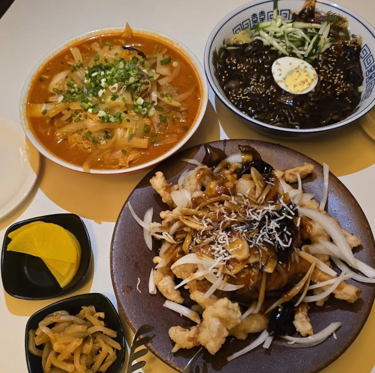 Table set with jjajangmyeon, jjamppong, and tangsuyuk