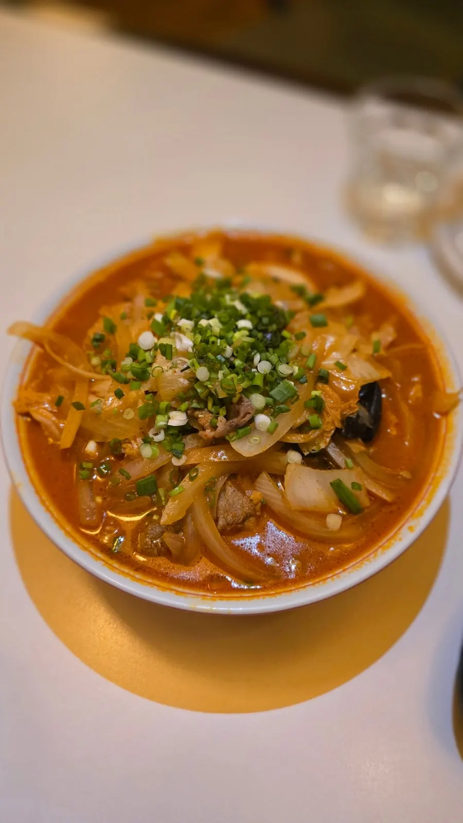 Red jjamppong broth topped with beef brisket and vegetables