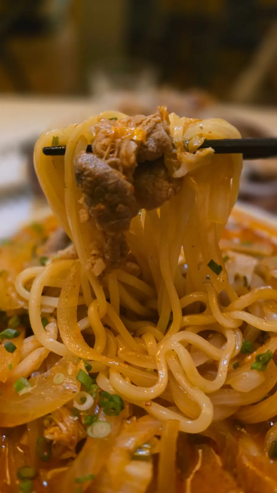 Noodles and beef brisket lifted together from the jjamppong