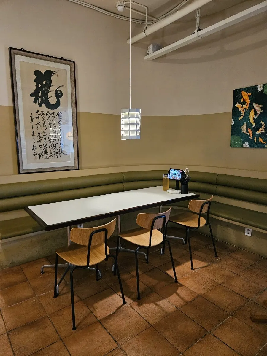 Curved booth-style sofa seating divided by curved walls