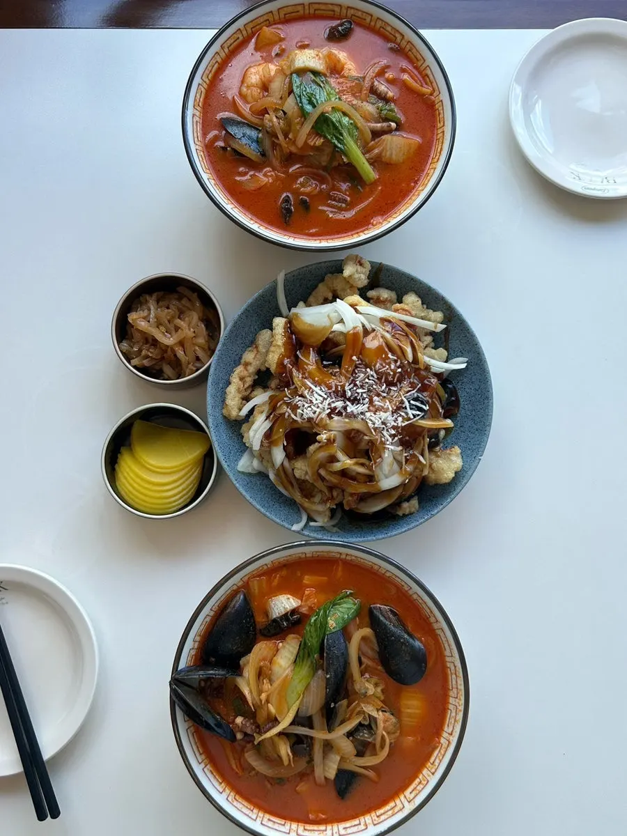 Table set with seafood jjamppong and black vinegar pork