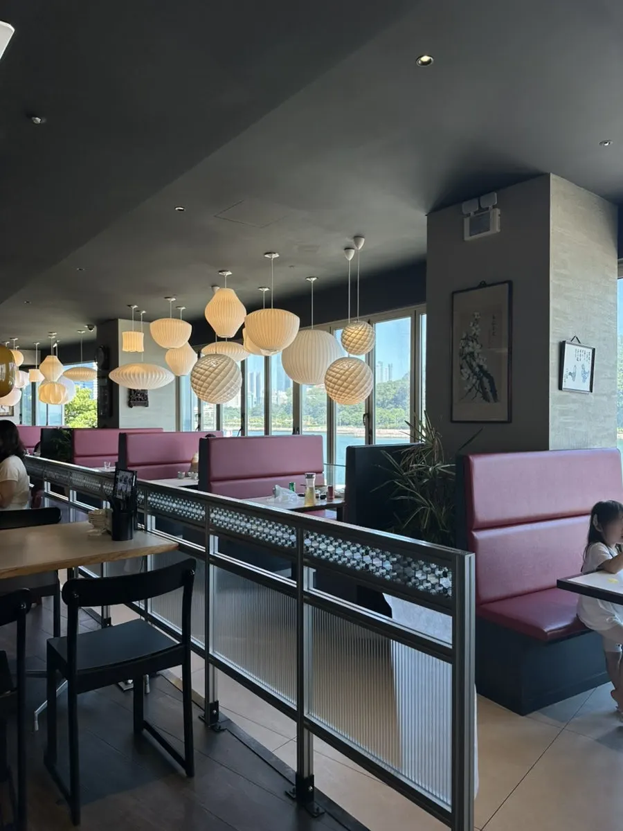 View of the dining hall with the Haeundae sea visible through floor-to-ceiling windows