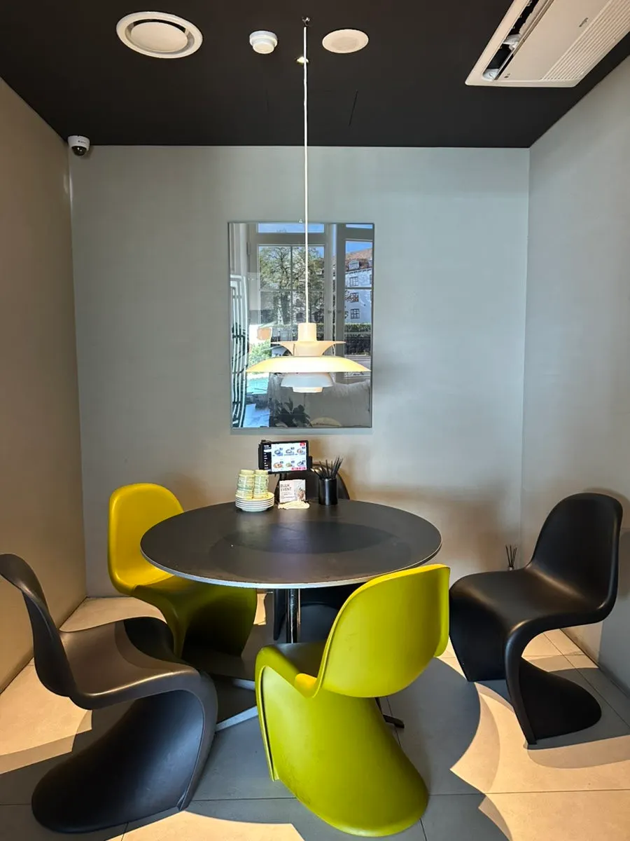 Interior space with a private room and group seating