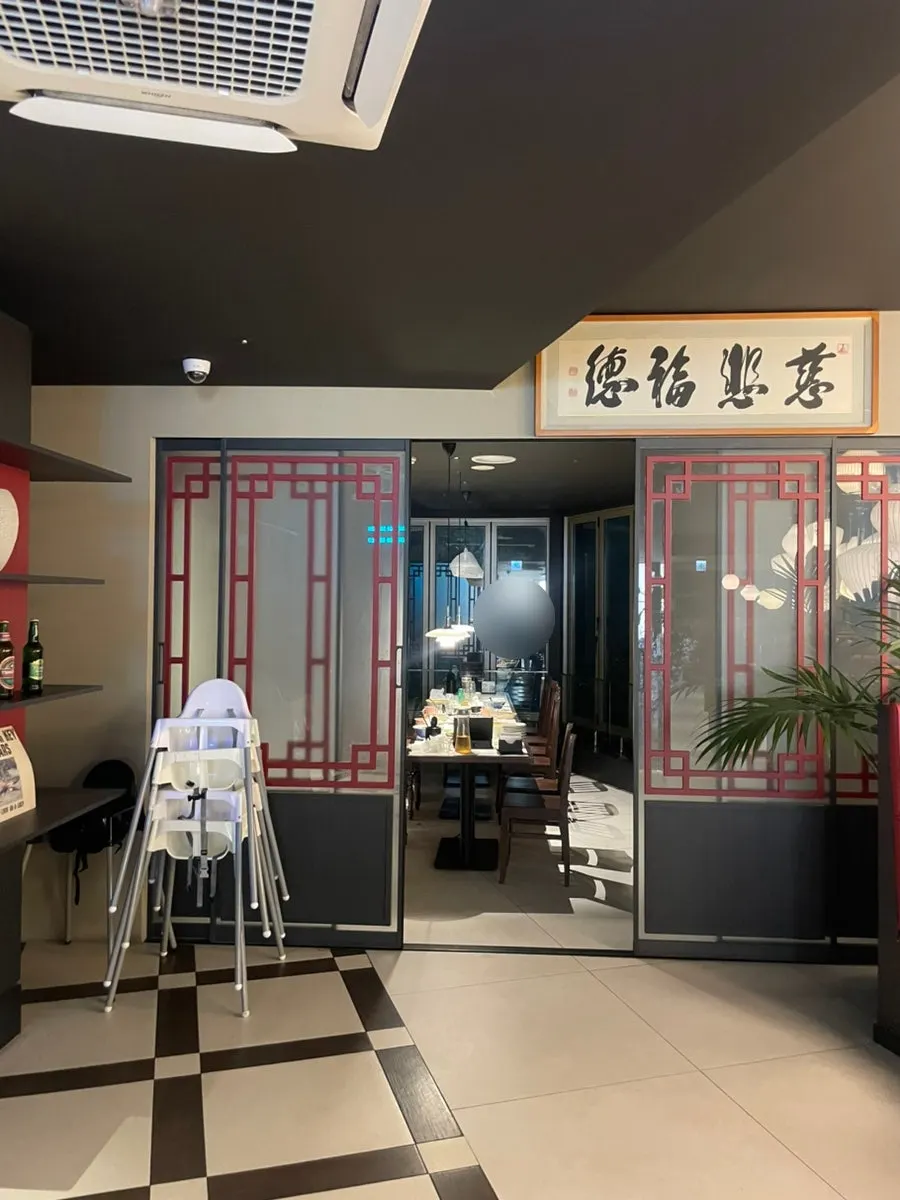 A full spread of Chinese dishes at a window table overlooking the sea