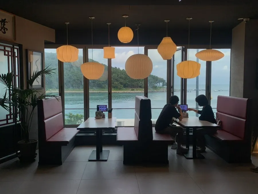 Window seat with the sea visible through large windows