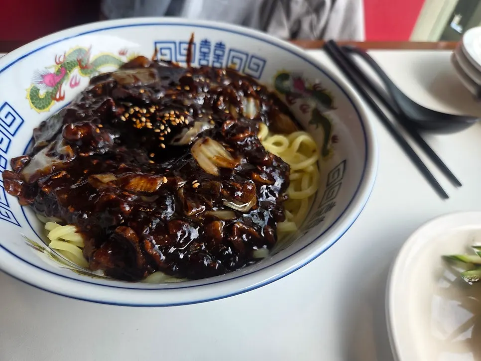 Noodle menu listing BUUK jjajangmyeon and poached-egg ganjajang
