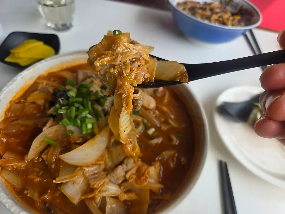 Jjamppong broth loaded with ingredients and noodles