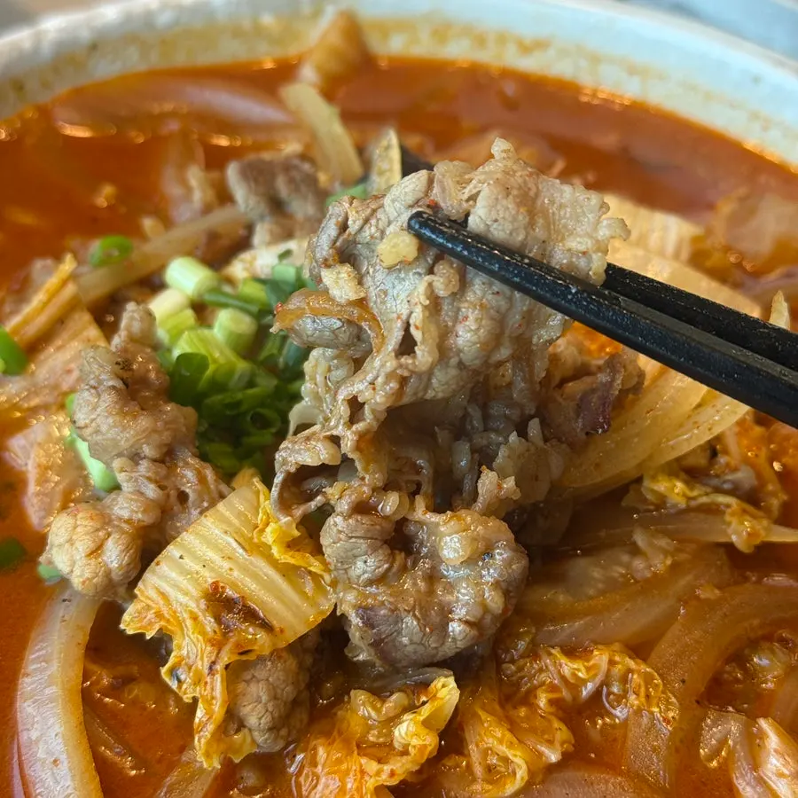 Close-up of beef brisket jjamppong topped with brisket
