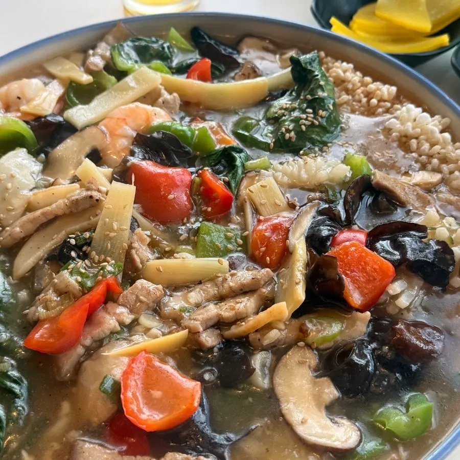 A spoonful of scorched rice soaked in the broth