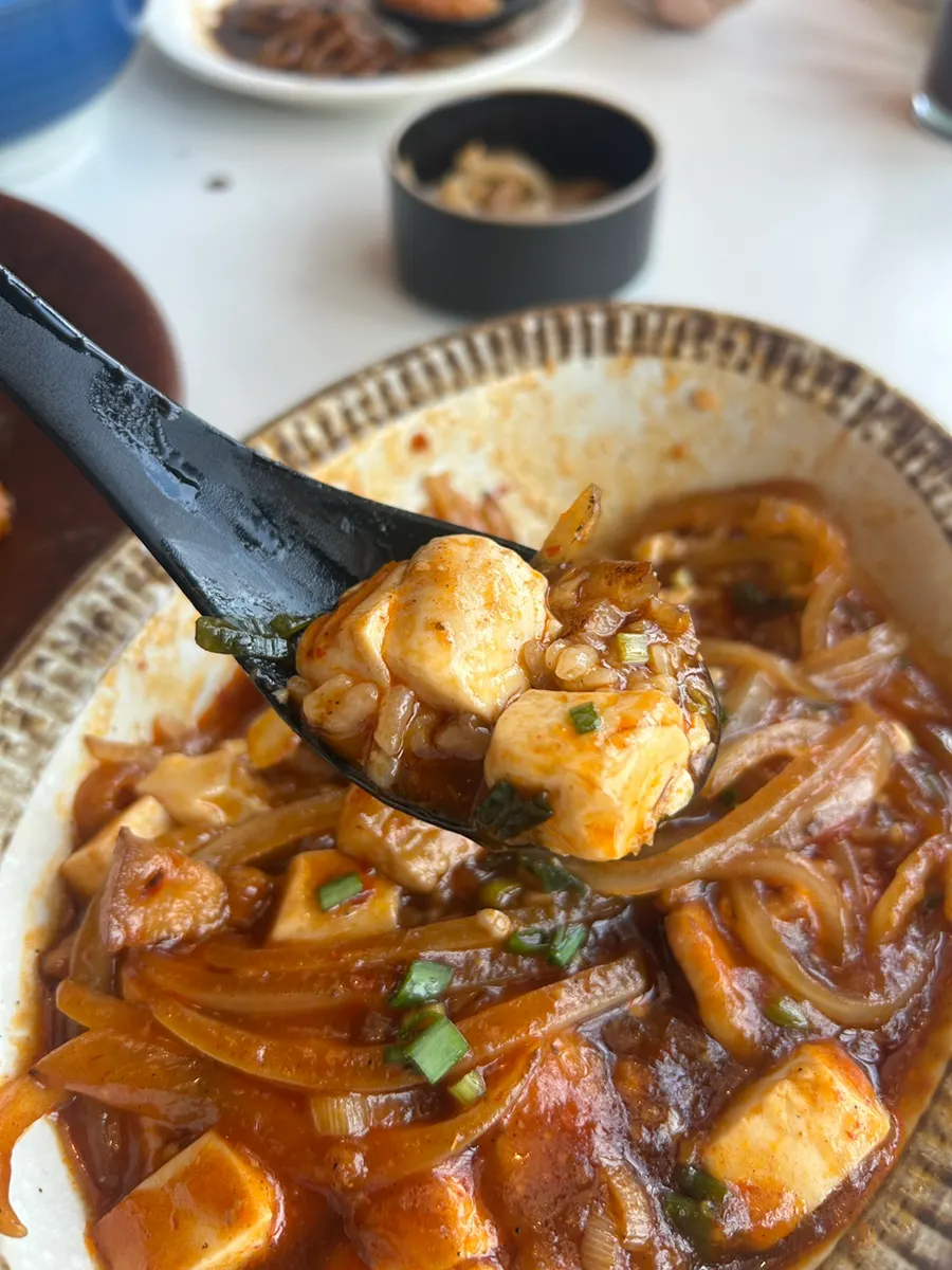 Mapo tofu ladled generously over rice