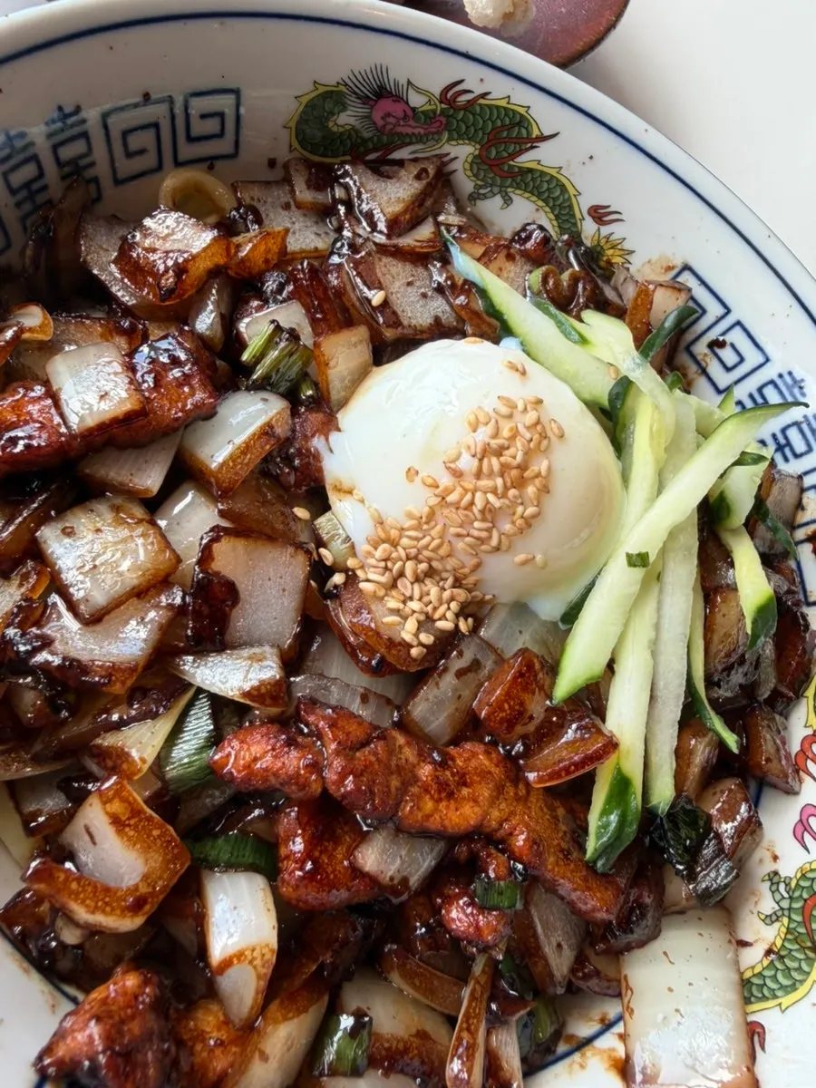 Ganjajang mixed together with the burst poached egg