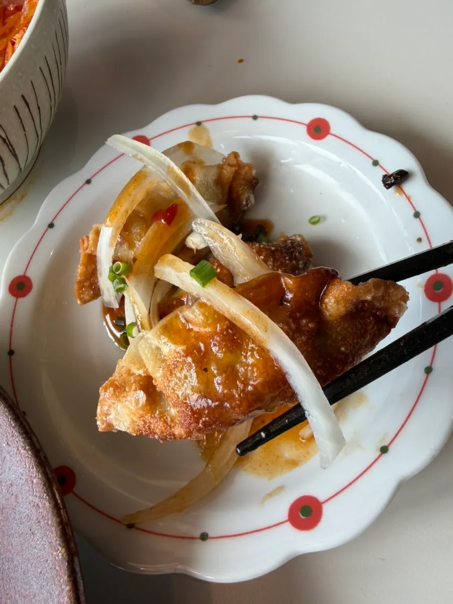 Close-up of fried dumplings topped with eohyang sauce