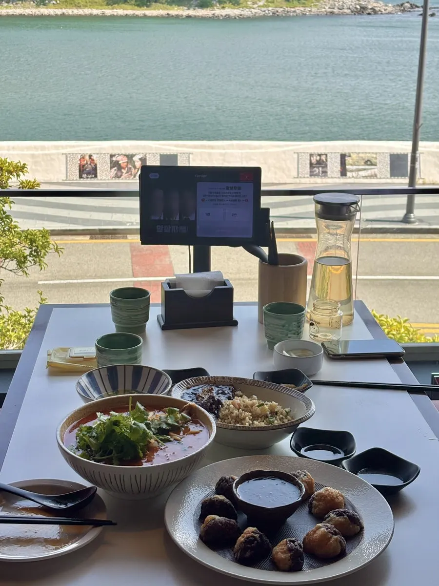 Food placed by the window with ocean view