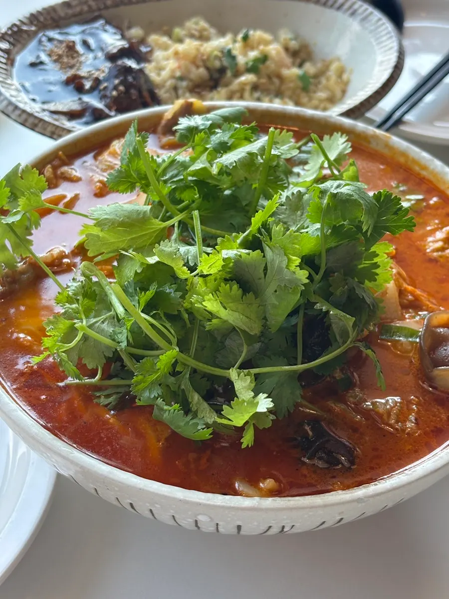 Noodles topped with coriander in the mala jjamppong
